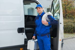 plumber standing outside van