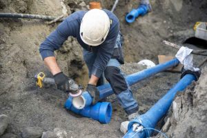 technicians working on sewer line replacement project