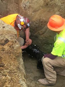 technicians performing trenchless pipe replacement