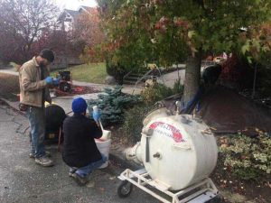 technicians repairing damaged underground sewer line