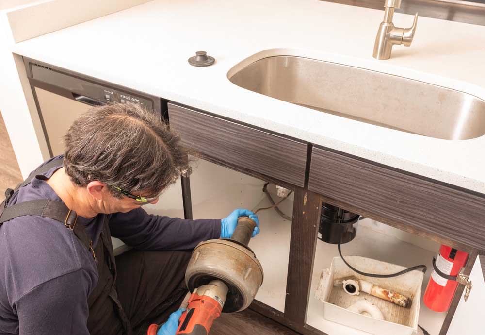 technician preparing drain snaking equipment Bellevue