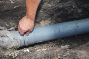 technicians replacing sewer pipe