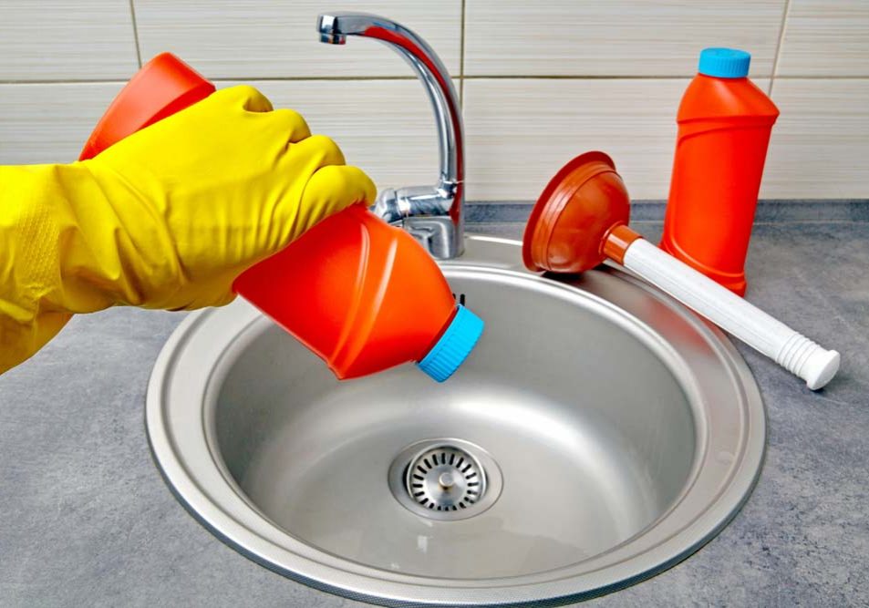 a person pouring chemical drain cleaner down the sink Kirkland, WA