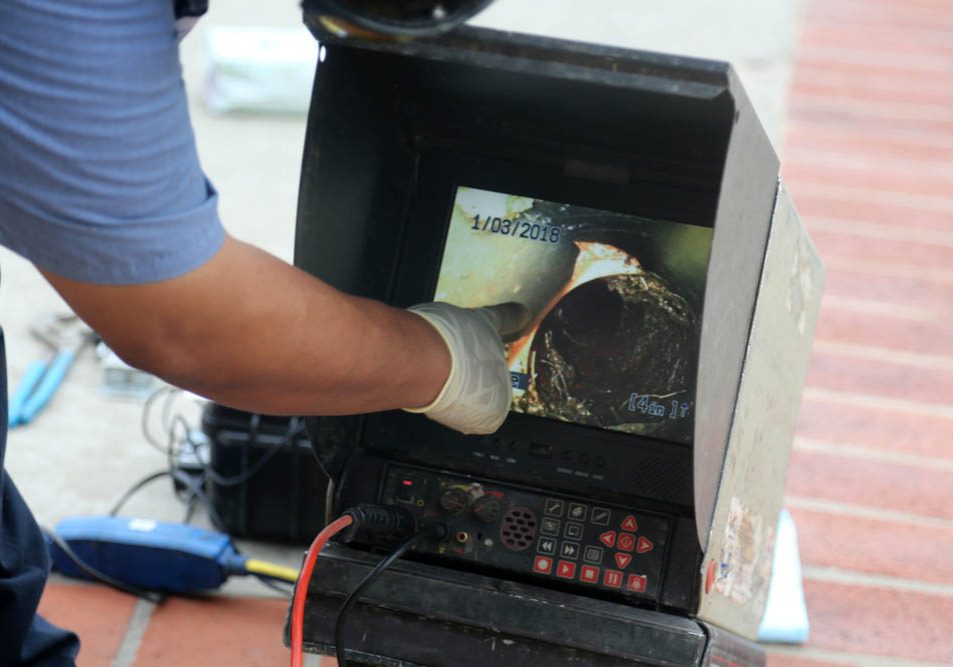 technician watching footage from sewer camera inspection