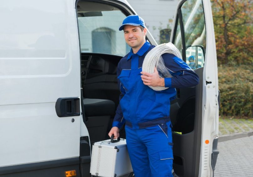 plumber standing outside van