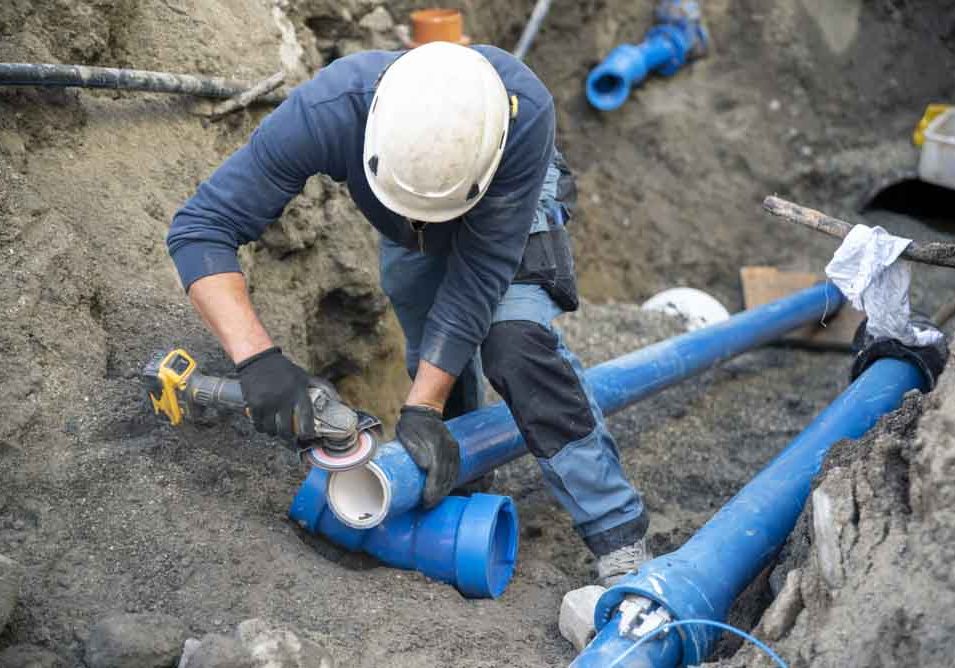 technicians working on sewer line replacement project